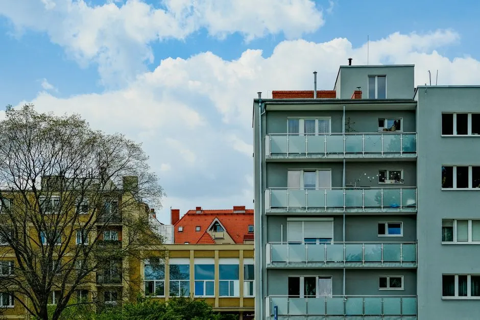 Multi-story apartment buildings in a city, illustrative of the mid-rise style common in modern public housing developments